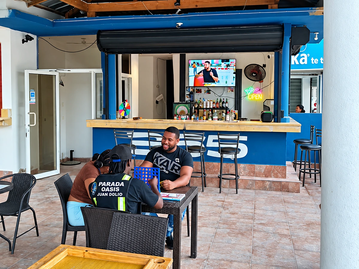 Guests playing Connect Four at a patio table in front of the 365 Beach Bar counter
