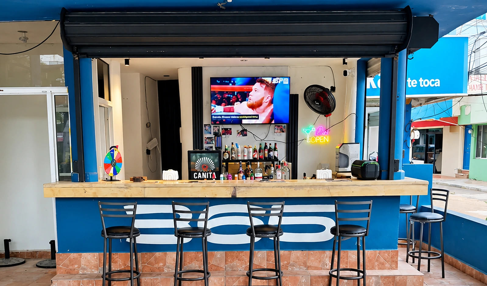 The 365 Beach Bar at Plaza Oasis in Juan Dolio — a blue bar front lettered 365, a row of bar stools, a timber counter with a TV, neon OPEN sign and shelf of bottles behind