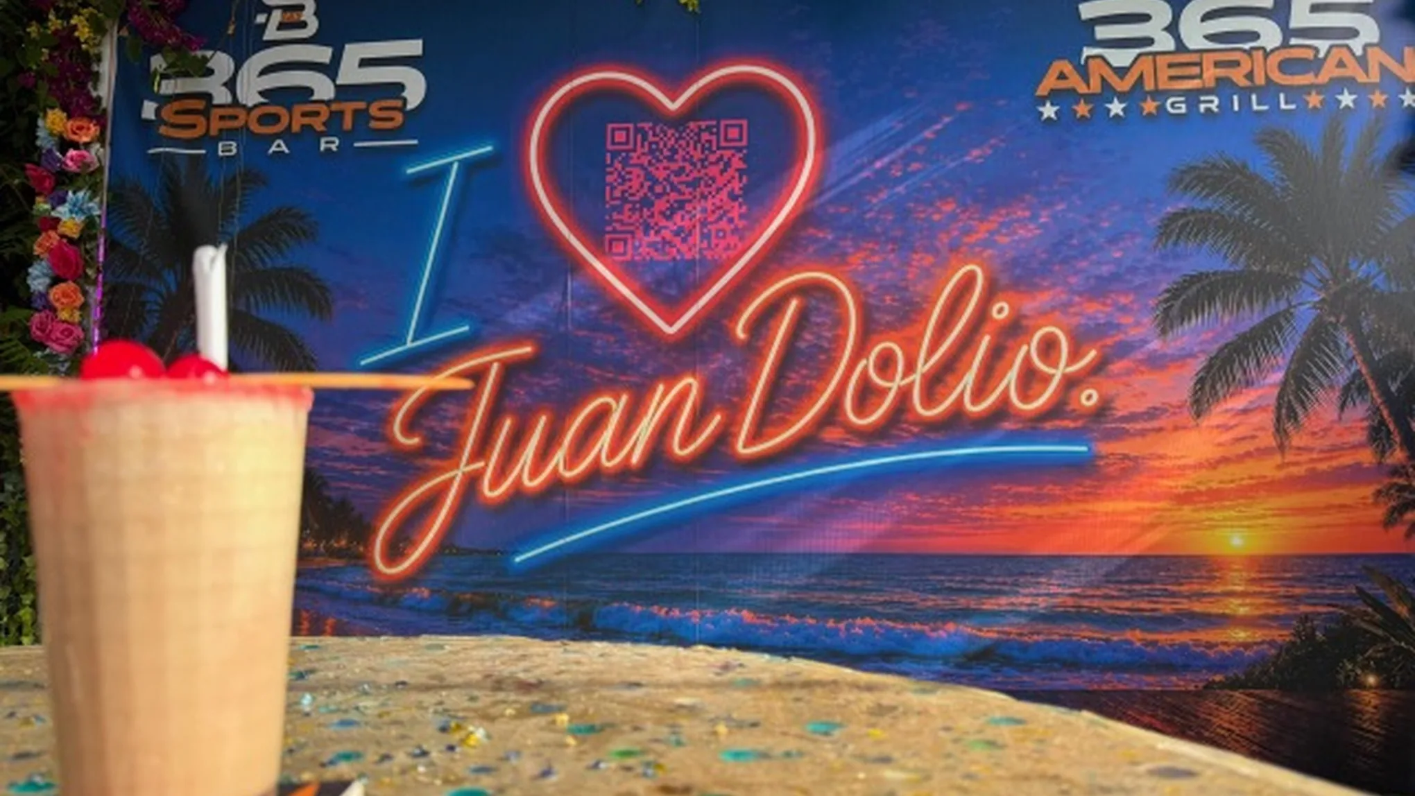 A frozen Pina Colada in front of the I love Juan Dolio photo sign at 365