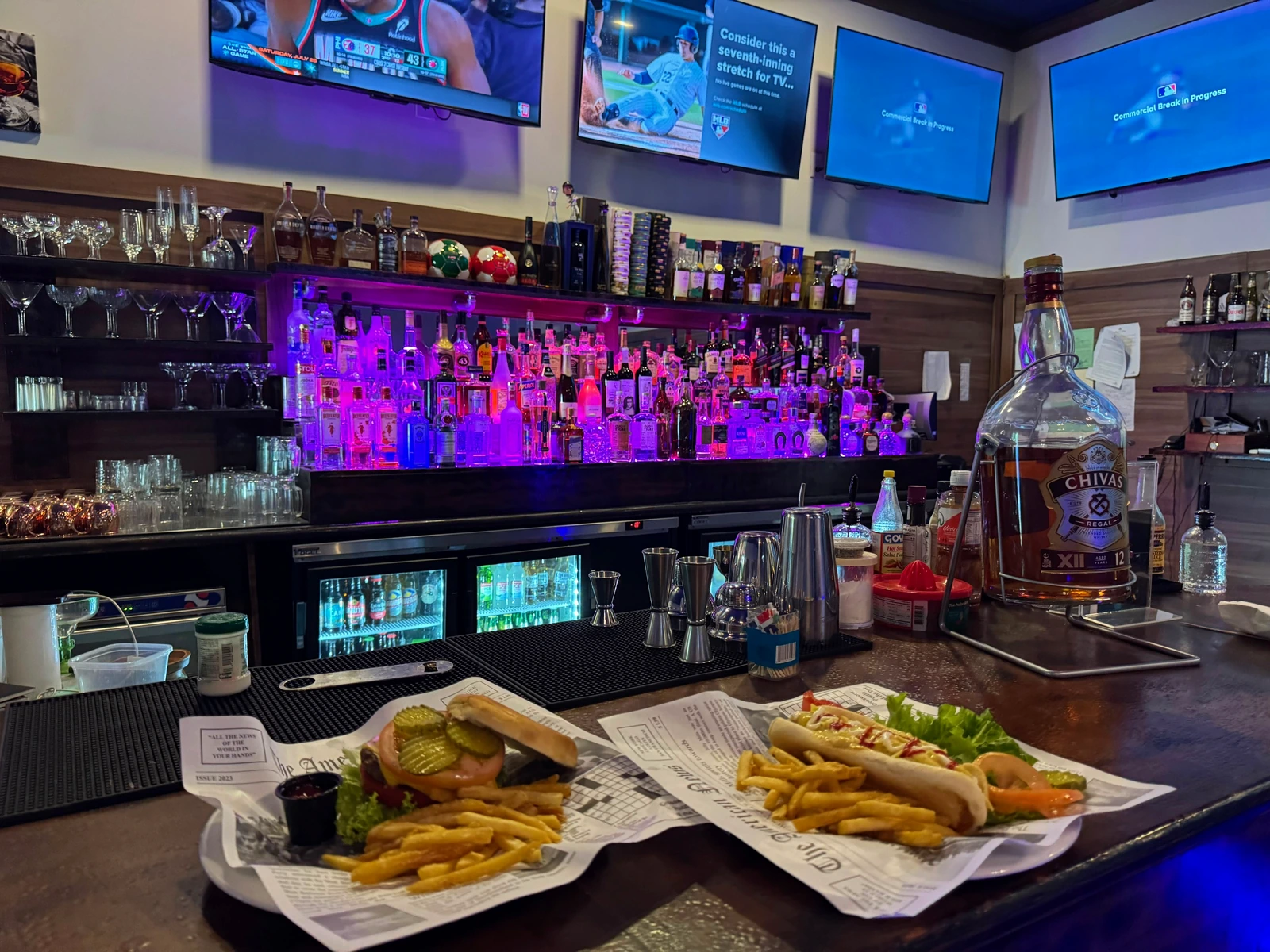 A plate of food from the 365 American Grill kitchen, served in front of the big screens
